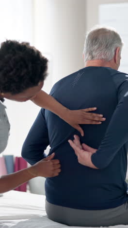 physical therapist treating patient's back pain