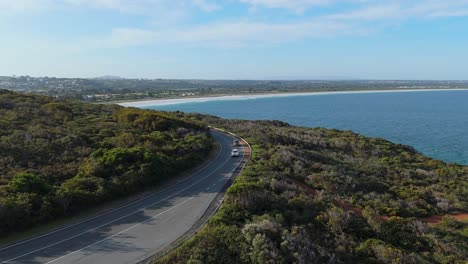 scenic coastal road with busy afternoon traffic as the sun sets