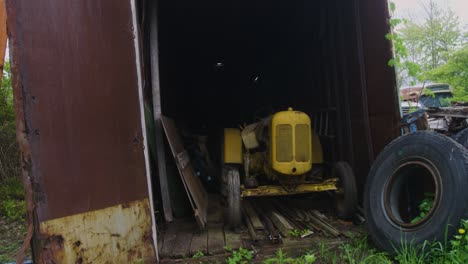 abandoned tractor sitting in a shipping container protected from the elements waiting to be restored