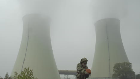 Person in a protective suit measures radiation outside