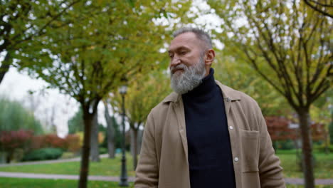 Relaxed-man-walking-in-autumn-park