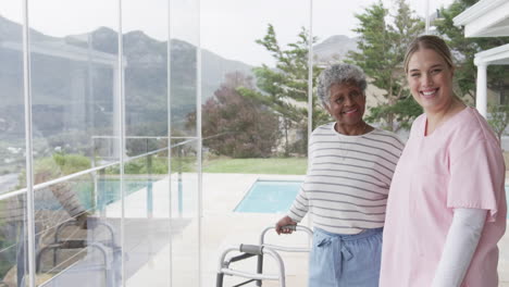 Smiling-caucasian-nurse-with-senior-woman-patient-with-copy-space,-slow-motion