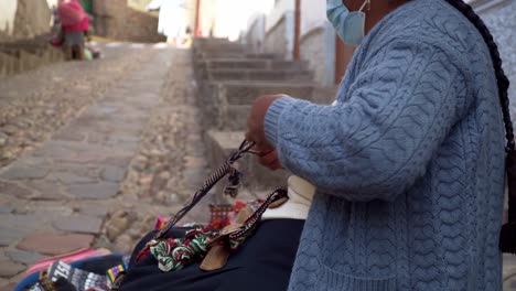 native cusco women weaving traditinal loom on the streets of cusco 4k 2.mp4