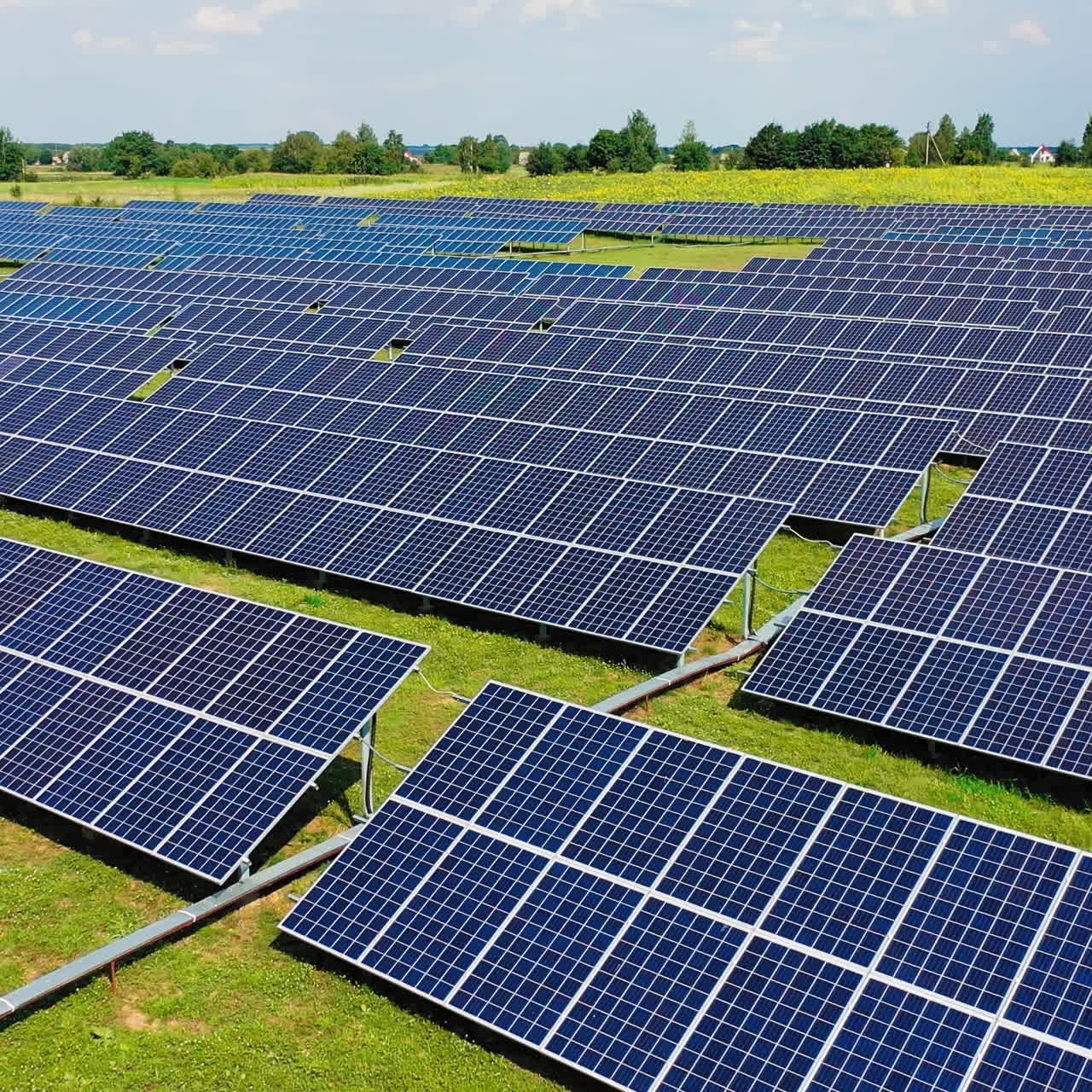 Solar panels in the countryside. Flight over the innovation plant of creating ecological energy at daytime. Eco light from solar panels.