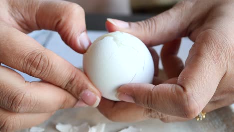 women hand perfectly peeled boiled eggs