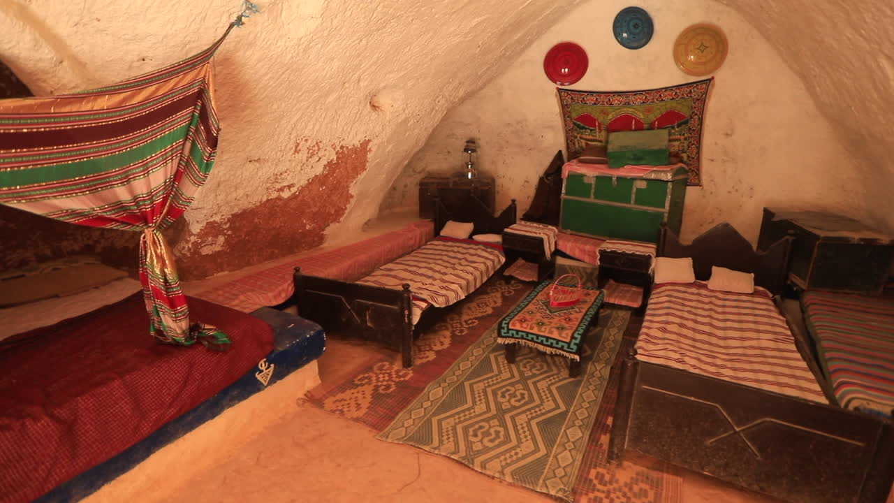 Traditional Tunisian Ksar house interior with colorful bedding and rustic decor