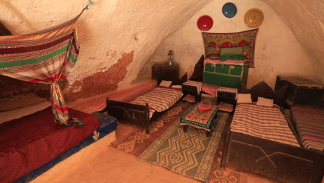 traditional tunisian ksar house interior with colorful bedding and rustic decor