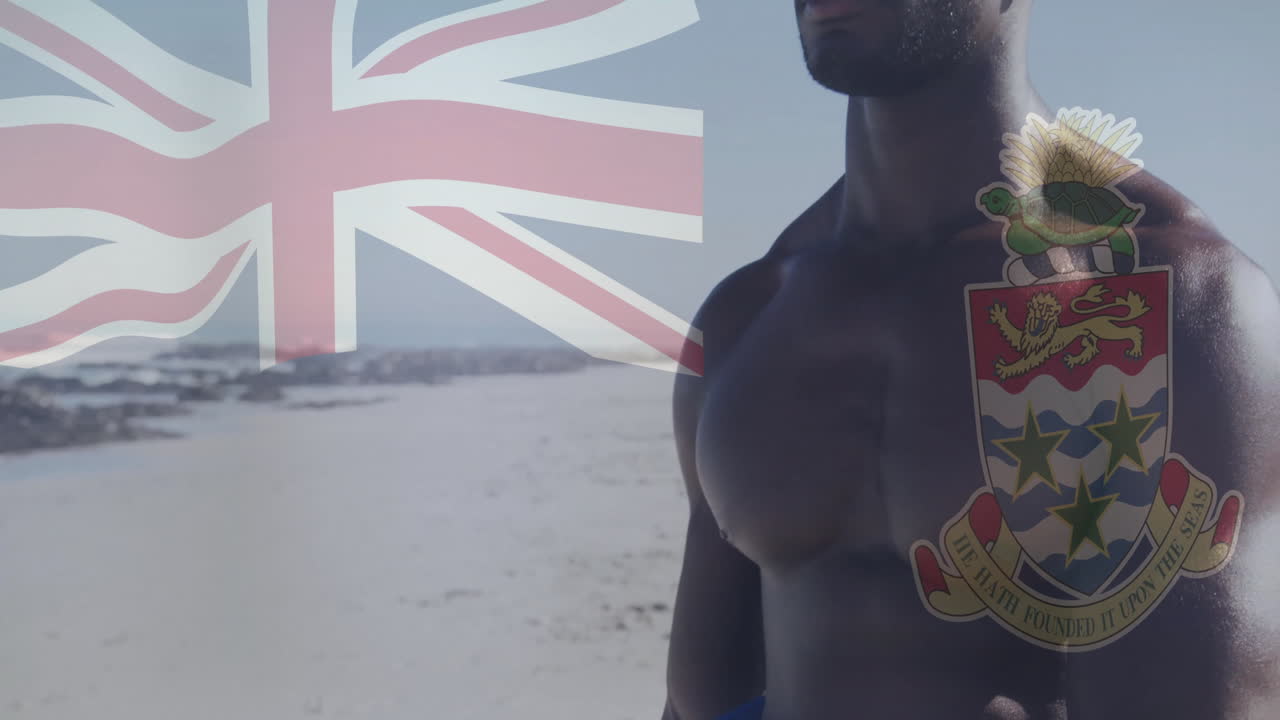 Holding Cayman Islands flag, muscular man standing on beach with animation overlay