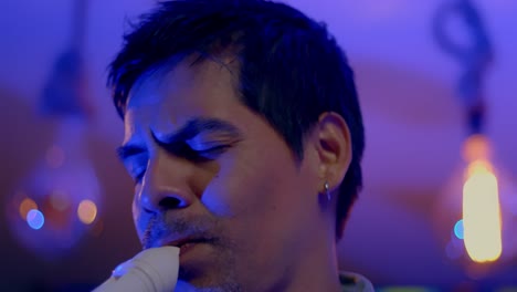 close up shot of musician playing recorder while closing his eyes