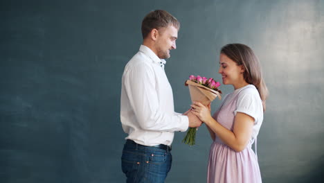 couple exchanging a bouquet of flowers