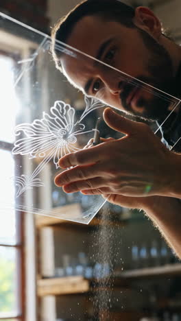 craftsman engraving glass with flower design