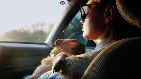 a woman is driving with a dog in a car