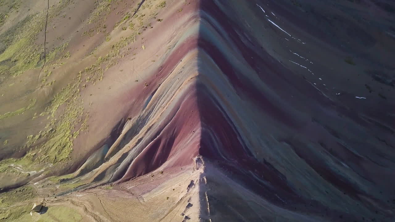 Stunning aerial view of Rainbow Mountain with its colorful stripes and rugged peaks in a remote mountainous area