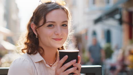 happy woman enjoying drinking morning aroma coffee hot drink, relaxing taking a break in city street