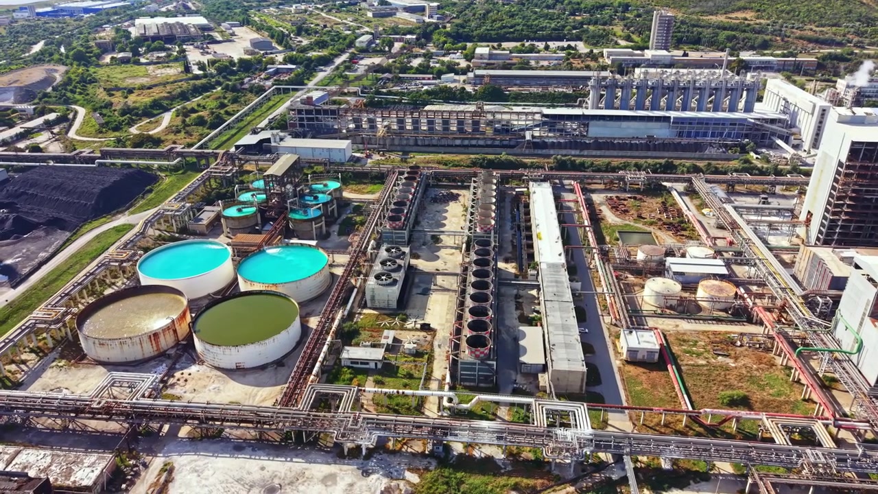 Industrial complex with storage tanks and facilities in a rural area during daylight