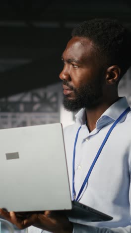 vertical video technicians on data center industrial platform analyzing performance outputs