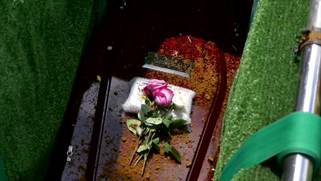 closeup shot of a funeral casket in a hearse or chapel or burial at cemetery