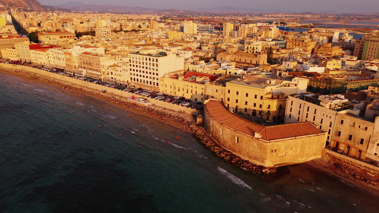 Aerial view of Trapani, Sicily at sunset by the coast, warm, inviting atmosphere