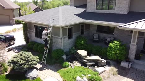 drone shot of a gutter inspection from a ladder by a handy man carpenter