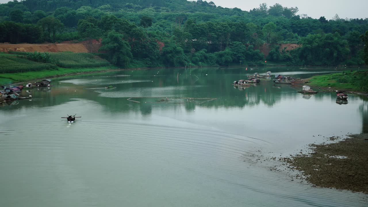 River Scene with Floating Houses and Lush Greenery