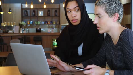 female executives discussing over laptop 4k