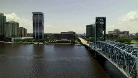 A-hyper-lapse-of-the-bridge-over-Saint-Johns-River-in-Jacksonville,-Fl-on-a-summer-day-with-cars-rushing-across-the-bridge-and-clouds-slowly-rolling-by