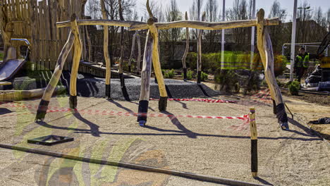 Workers-building-kids-playground-on-sunny-day,-fusion-time-lapse