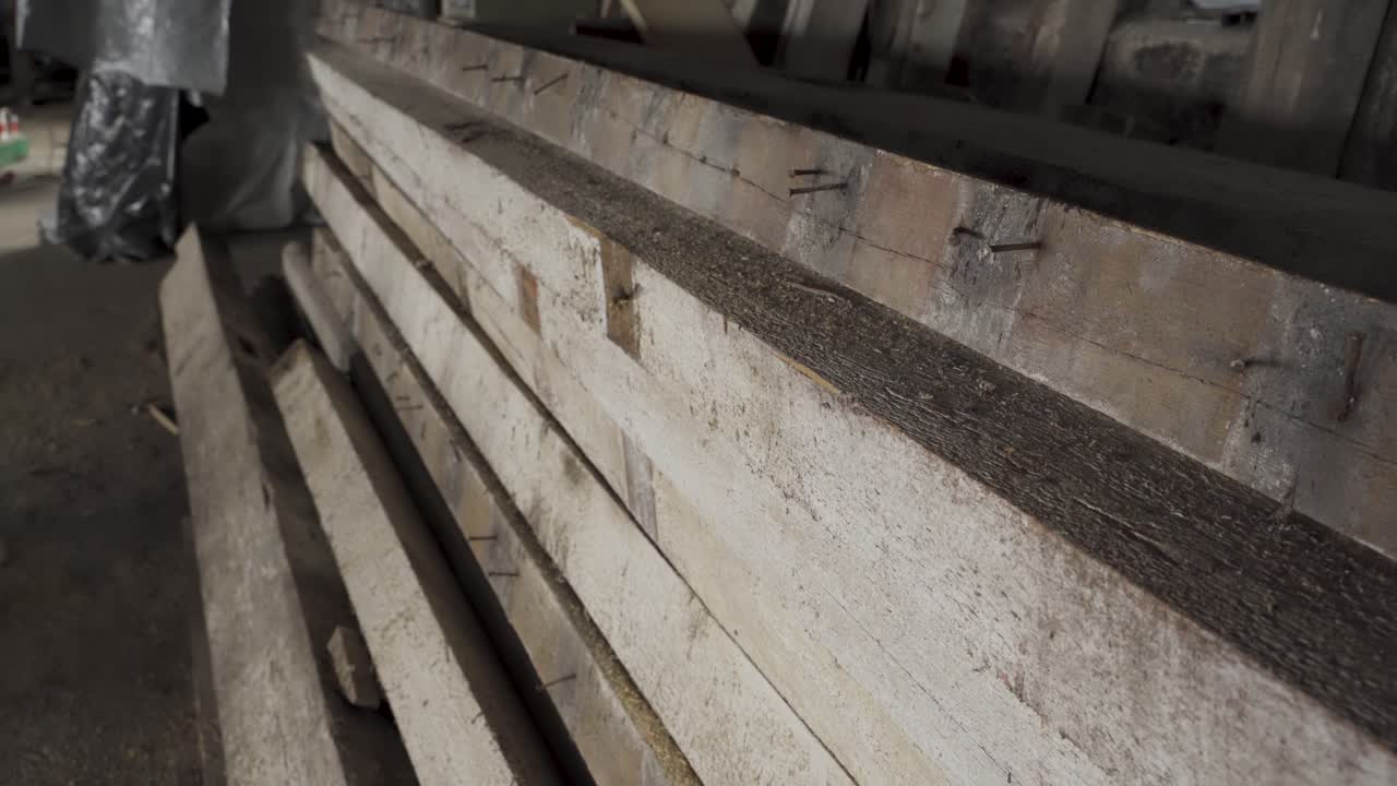 Demolition wooden beams with nails, close up handheld shot