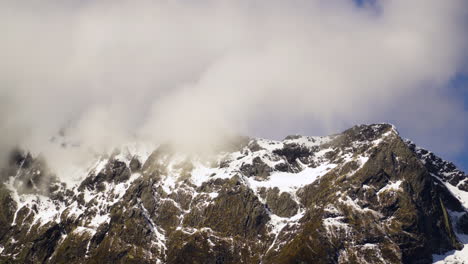 Clouds-passing-over-mountain-tops-in-Fiordland,-New-Zealand