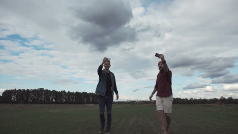 friends taking selfie and drone near airport