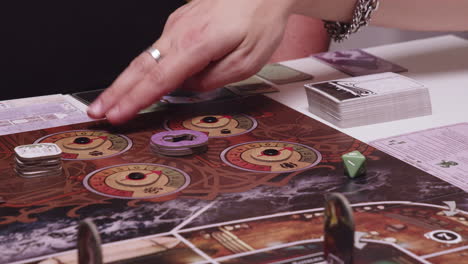 explaining board game rules, detail view of hands pointing on playing desk area