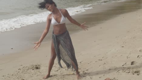 sexy girl in a bikini dancing on the beach of the caribbean island of trinidad