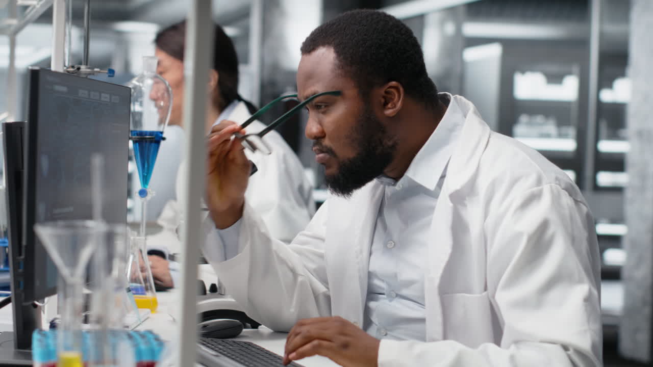 Vertical video Lab specialist does genetics study using clinical equipment, removing eyeglasses