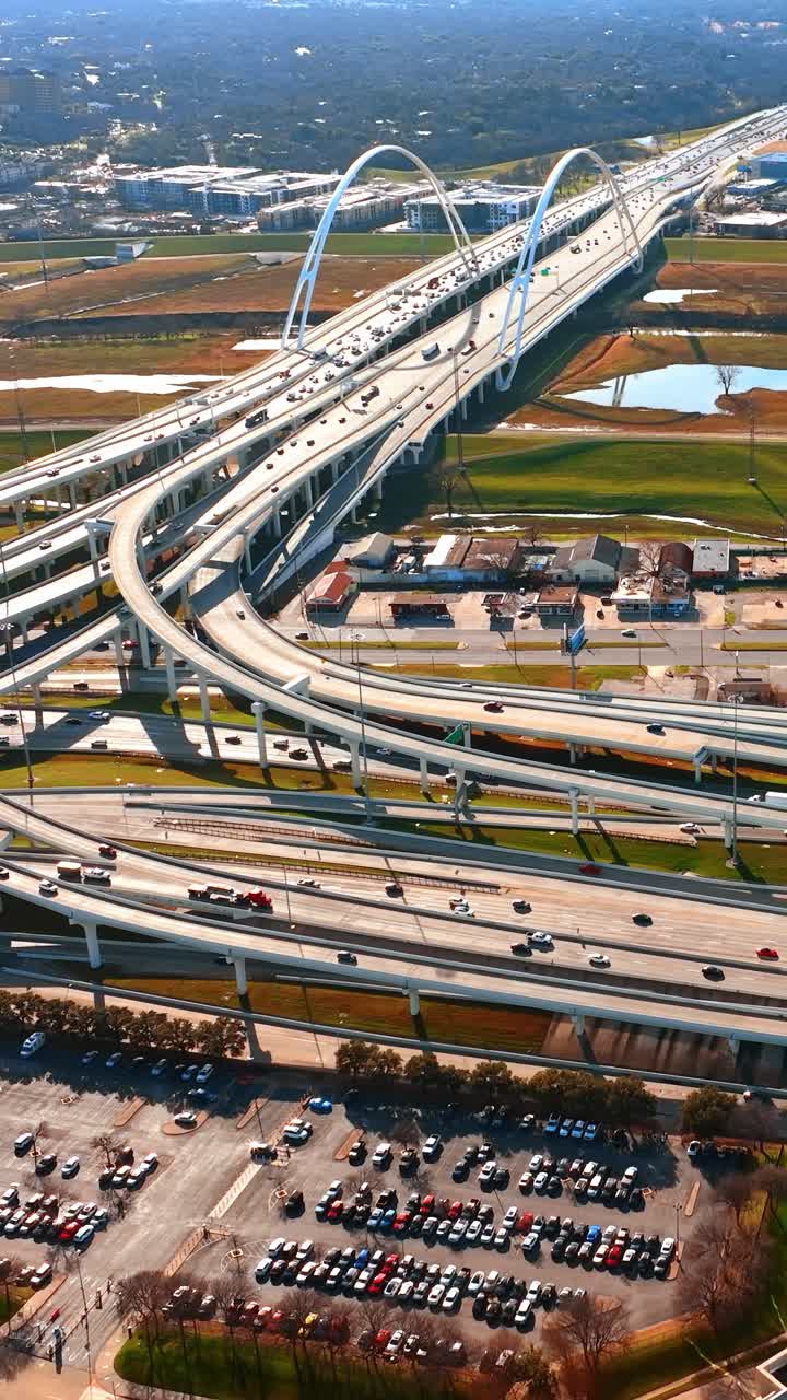 Approaching the spherical top of Reunion Tower and Margaret McDermott Bridge with lively traffic. Aerial view on Dallas, Texas, USA on sunny day. Vertical video
