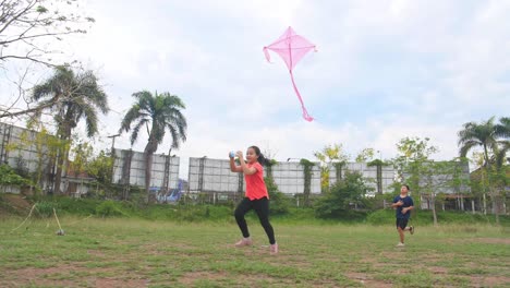 children flying a kite in a park
