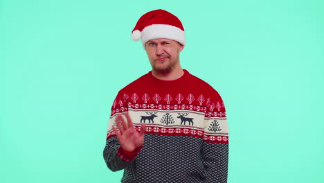 Confused-man-in-sweater-Santa-Christmas-hat-pointing-fingers-himself-ask-say-who-why-me-no-thanks