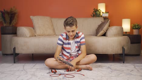niño inteligente feliz trabajando con materiales tecnológicos.