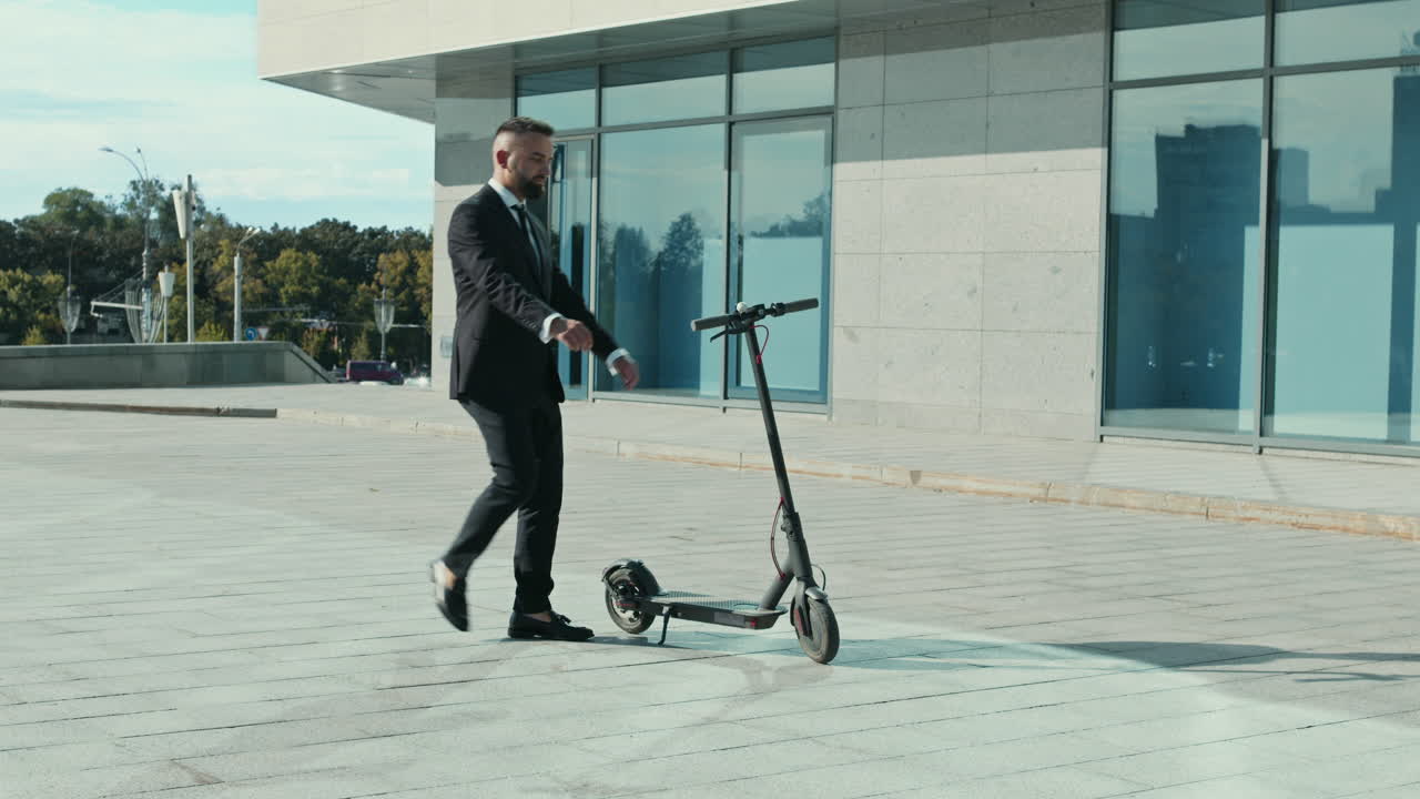 Businessman Riding an Electric Scooter in Front of a Modern Office Building