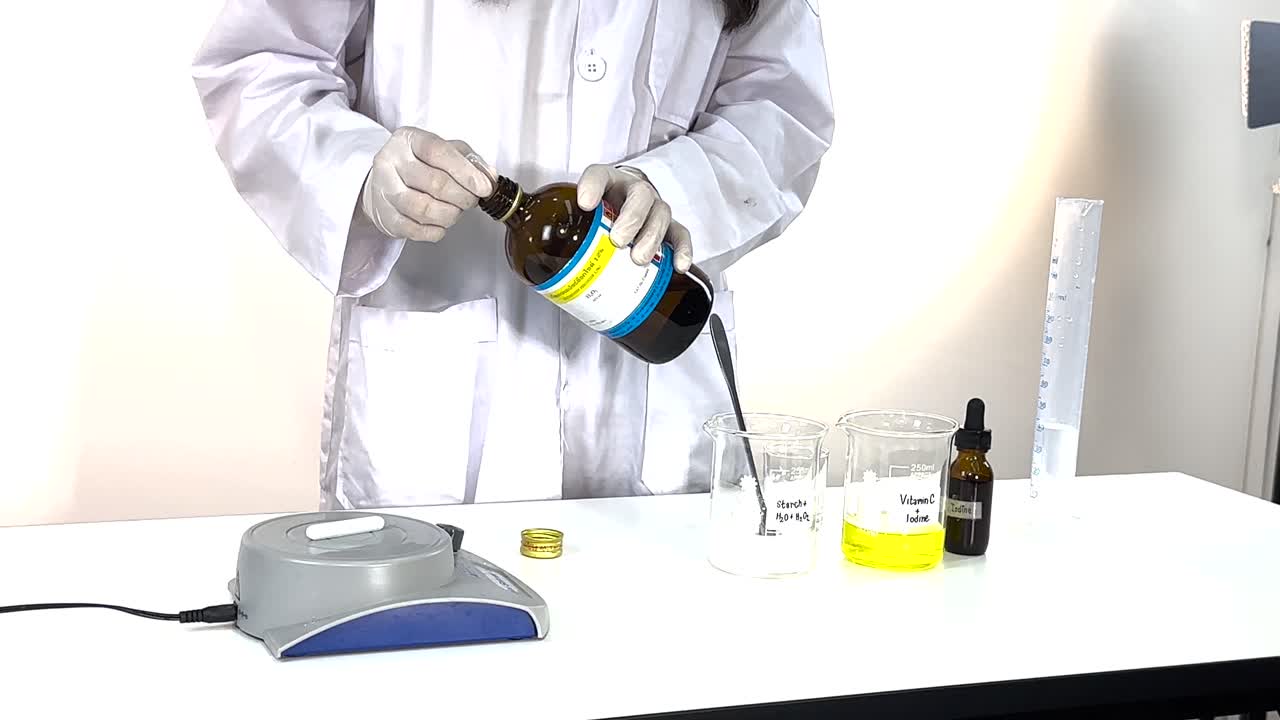 A scientist performs an iodine clock reaction in a lab setting, demonstrating chemical changes with clear liquids and precise measurements