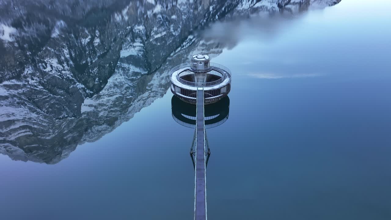 Aerial circular water intake tower on Klöntalersee in Klöntal, Switzerland, serene view