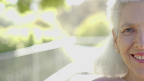 Portrait-of-happy-senior-biracial-woman-at-balcony-at-home,-slow-motion,-copy-space