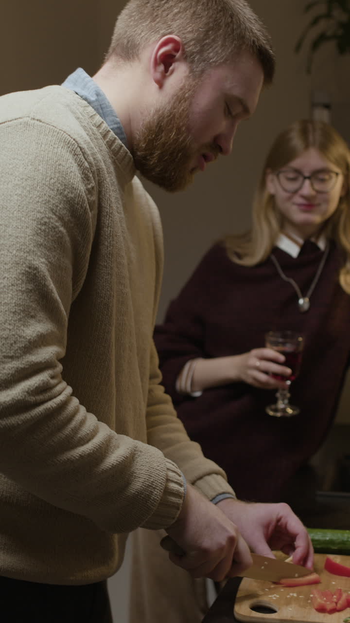 Couple preparing food and having wine in the kitchen