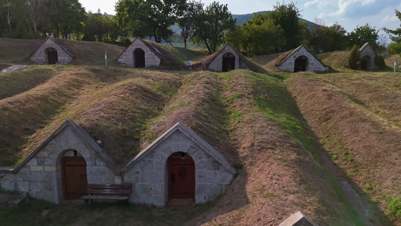 Spectacular view of the triangular-gabled entrances and underground layout of the Kőporosi Pincesor wine cellars in Hercegkút, Hungary