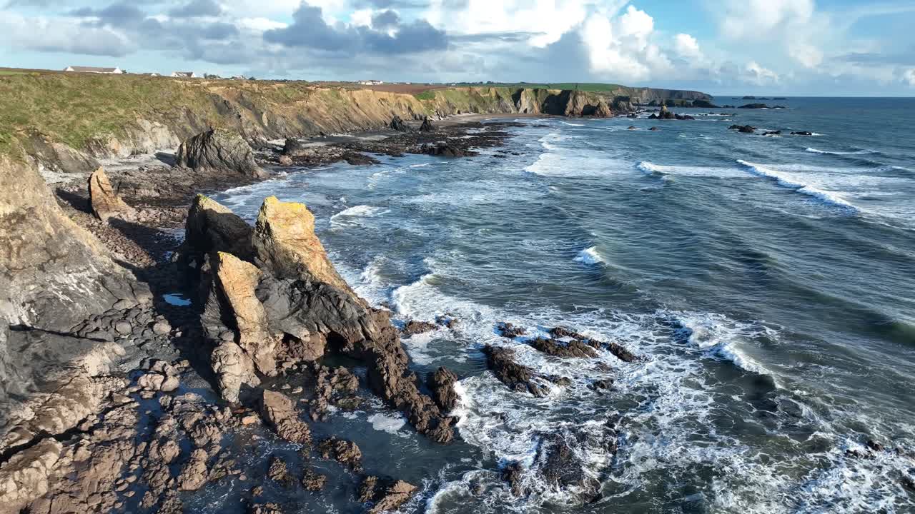 Ireland seascapes drone flying along epic coast at Garrus Copper Coast Waterford strong incoming waves and tides