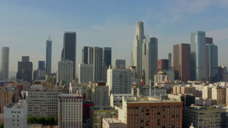 Skyline-of-Los-Angeles,-California-Downtown-City-Skyscrapers-on-Summer-Day,-Aerial-Drone-perspective-wide-shot
