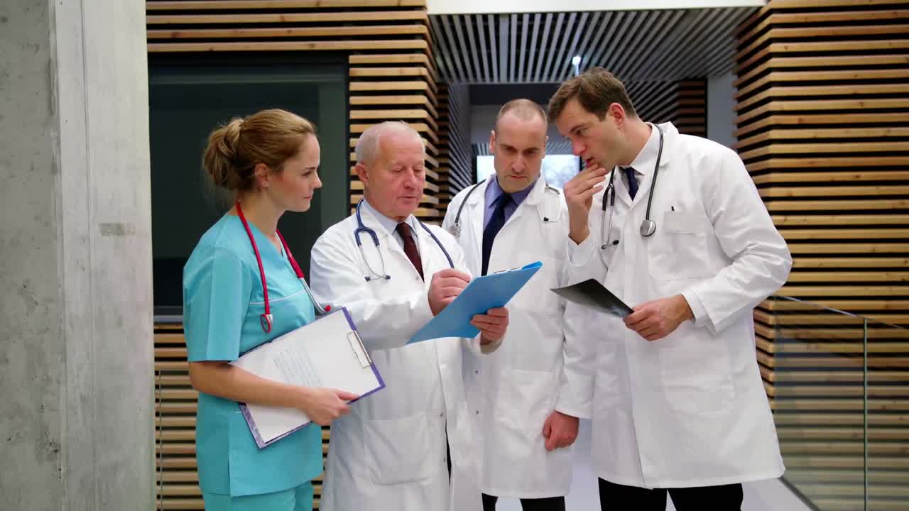 Team of doctors discussing over medical report