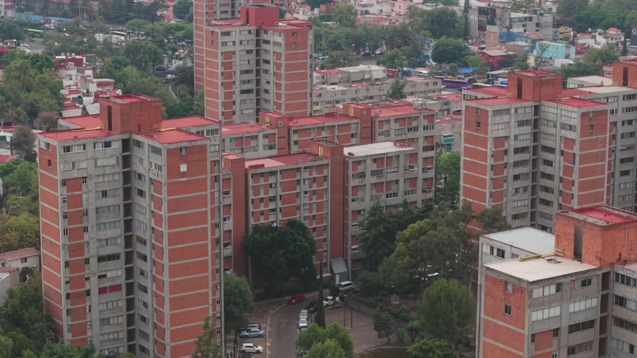 Overhead drone footage of Copilco's reddish residential buildings