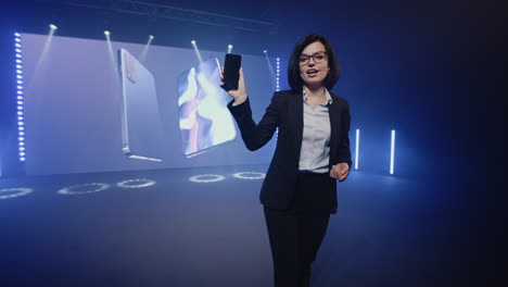 businesswoman presenting smartphone at product launch