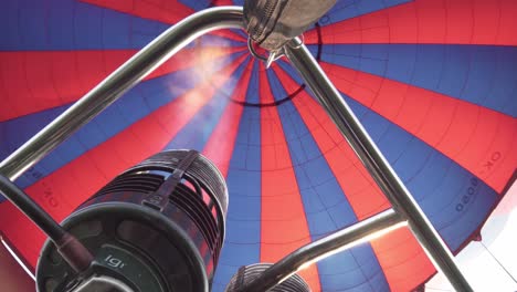 Inflating-hot-air-balloon,-close-up-of-flames-and-burner-during-flight