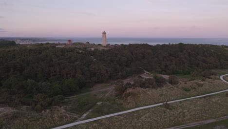 Panoramic-shot-of-dunes-and-forrest-at-West-Terschelling-during-sunset,-aerial